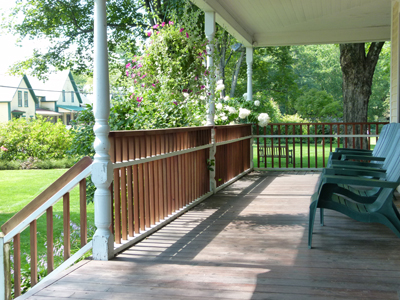 Relax on the porch of the Holderness Inn at Kirkwood Gardens